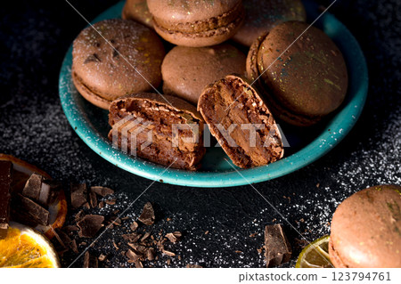 Macaroons with chocolate cream on a dark background Macaroons with chocolate cream on a dark background 123794761