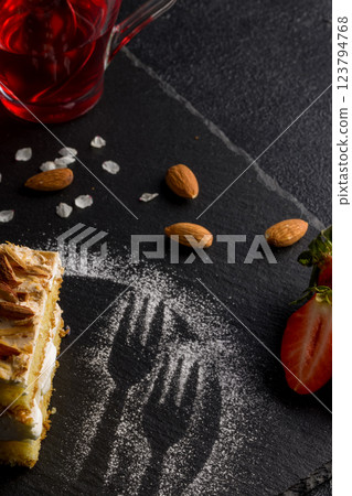 Norwegian cake. With meringue, whipped cream and almonds. Dark background Norwegian cake. With meringue, whipped cream and almonds. Dark background 123794768