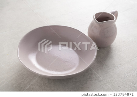 Pottery on a concrete light background 123794971