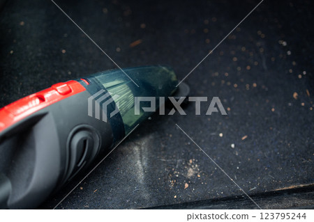 Cleaning the interior of the car with a vehicle vacuum cleaner. 123795244