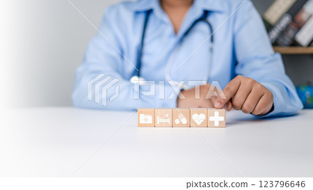 Health insurance concept, Health and access to welfare health concept, Doctor hand holding wooden stacking with healthcare medical and hospital icons on table, Plus sign on block, Your health concept. 123796646