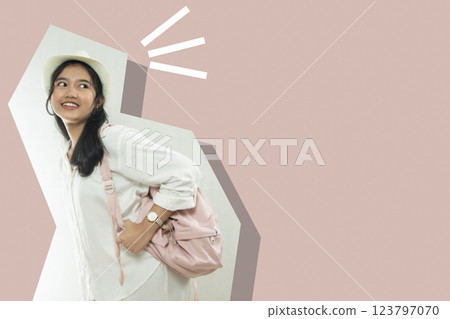 Portrait of a beautiful young woman in a white shirt and pink bag posing happily to travel. isolated clipping path. negative space 123797070