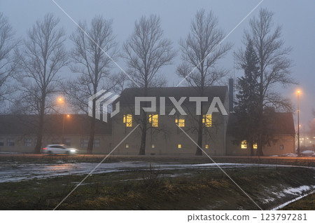 A foggy winter evening sets a mysterious and melancholic tone in this urban landscape. A foggy winter evening sets a mysterious and melancholic tone in this urban landscape. 123797281