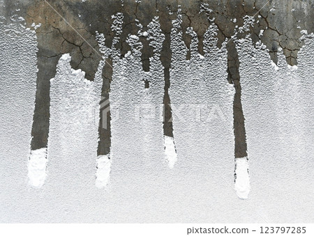 beauty of frost and snow accumulating on a cracked concrete surface 123797285