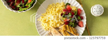 A nutritious and balanced breakfast with millet, baked chicken breast, a fresh salad with greens and grapefruit, providing protein, fiber, and vitamins for energy, banner A nutritious and balanced breakfast with millet, baked chicken breast, a fresh salad with greens and grapefruit, providing protein, fiber, and vitamins for energy, banner 123797759