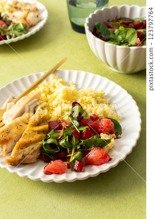 A balanced breakfast with millet, tender baked chicken breast, a refreshing salad of greens and grapefruit, offering a nutrient-packed meal A balanced breakfast with millet, tender baked chicken breast, a refreshing salad of greens and grapefruit, offering a nutrient-packed meal 123797764