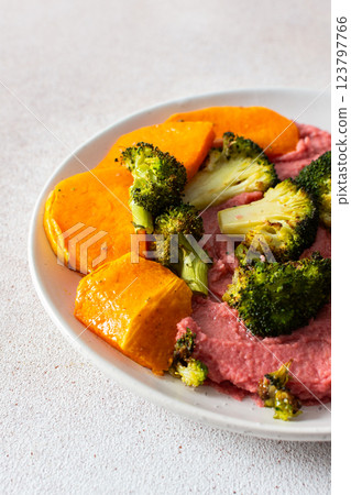 A healthy, balanced breakfast with beetroot hummus, roasted sweet potatoes, and broccoli, topped with a fresh pink radish and Chinese cabbage salad with chia seeds A healthy, balanced breakfast with beetroot hummus, roasted sweet potatoes, and broccoli, topped with a fresh pink radish and Chinese cabbage salad with chia seeds 123797766