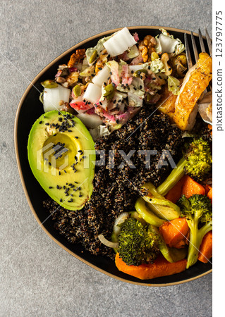 Nutritious, wholesome breakfast featuring quinoa, avocado, roast chicken, and roasted vegetables like sweet potato, zucchini, and broccoli, complemented with a fresh cabbage and radish salad Nutritious, wholesome breakfast featuring quinoa, avocado, roast chicken, and roasted vegetables like sweet potato, zucchini, and broccoli, complemented with a fresh cabbage and radish salad 123797775