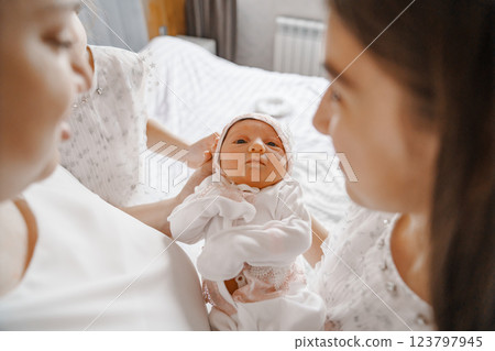 Happy mother with a newborn and older daughters. 123797945