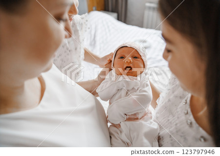 Happy mother with a newborn and older daughters. 123797946