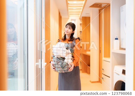 Housewife with a laundry basket Housewife with a laundry basket 123798068