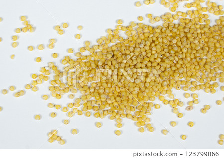 Whole millet grains on white background top view macro Whole millet grains on white background top view macro 123799066