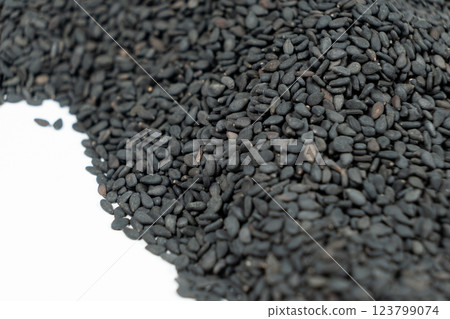 Black organic sesame seeds close-up on white background 123799074
