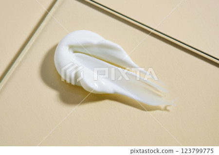 A smear of white cream on a beige background. A smear of white cream on a beige background. 123799775
