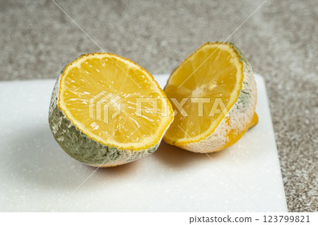 Rotten Lemon with Green and White Mold Spots 123799821