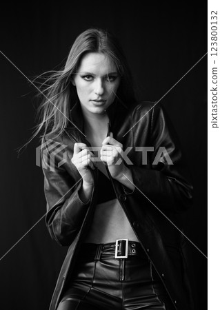 A Fashionable and Stylish Model Posing Confidently in a Chic Black Leather Outfit A Fashionable and Stylish Model Posing Confidently in a Chic Black Leather Outfit 123800132