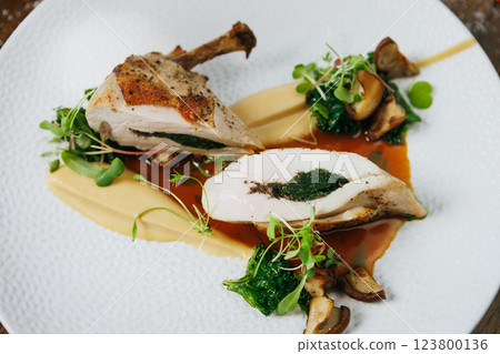 Exquisite Gourmet Chicken Dish Featuring a Savory Herb Filling and Colorful Vegetable Garnish Exquisite Gourmet Chicken Dish Featuring a Savory Herb Filling and Colorful Vegetable Garnish 123800136