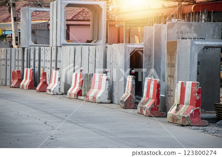 Concrete barriers divide construction areas on the road. 123800274