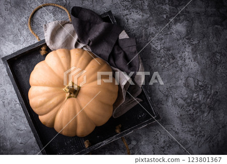 Raw fresh cut pumpkin on dark background Raw fresh cut pumpkin on dark background 123801367