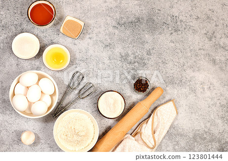 Kitchen background of food preparation with space for text. Culinary ingredients for making pie and bread, recipe with eggs, flour, sugar, honey, cinnamon, yeast and butter. Modern bakery concept, 123801444