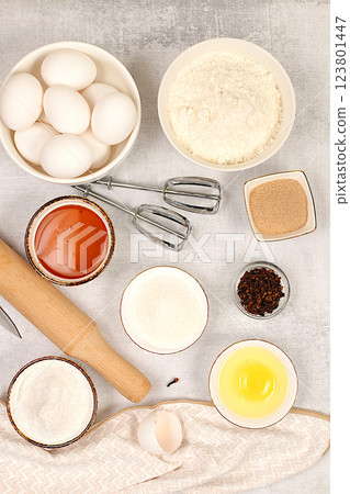 Recipe with eggs, flour, sugar, honey, cinnamon, yeast and butter. Kitchen background of cooking. Culinary ingredients for making pie and bread, Modern bakery concept 123801447
