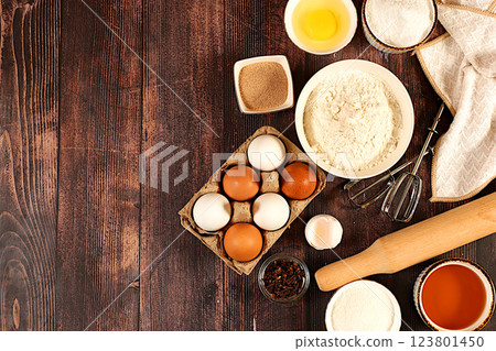 Kitchen background of food preparation with space for text. Culinary ingredients for making pie and bread, recipe with eggs, flour, sugar, honey, cinnamon, yeast and butter. Modern bakery concept, Kitchen background of food preparation with space for text. Culinary ingredients for making pie and bread, recipe with eggs, flour, sugar, honey, cinnamon, yeast and butter. Modern bakery concept, 123801450