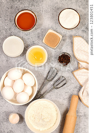 Kitchen background of food preparation.Culinary ingredients for making pie and bread,recipe with eggs,flour,sugar,honey,cinnamon,yeast and butter.Concept of modern bakery 123801451