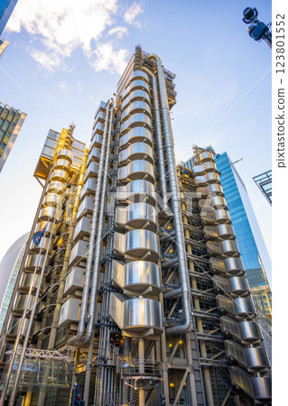 In London, the Lloyd's building stands out with its striking inside-out design. Its metallic exterior and unique structure highlight modern architecture in a vibrant urban setting. 123801552