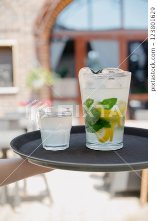 Cold refreshing lemonade or mojito with ice and mint leaves. Cold refreshing lemonade or mojito with ice and mint leaves. 123801629