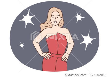 Celebrity woman poses for reporters standing in evening dress during film festival or award ceremony 123802030
