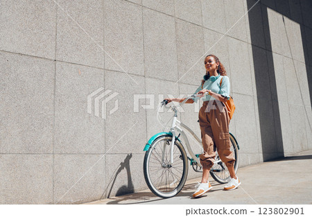 Bike, urban and city woman on a bicycle ride walking to cut carbon footprint for sustainability. Person relax after riding on a summer day feeling calm and relax with eco friendly transportation Bike, urban and city woman on a bicycle ride walking to cut carbon footprint for sustainability. Person relax after riding on a summer day feeling calm and relax with eco friendly transportation 123802901