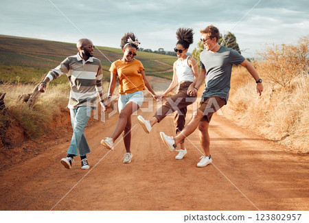 Travel, friends holding hands and dance in nature, outdoors or countryside on vacation. Happy, diversity and group smile, spending time together and dancing, celebration and having fun on sandy road. Travel, friends holding hands and dance in nature, outdoors or countryside on vacation. Happy, diversity and group smile, spending time together and dancing, celebration and having fun on sandy road. 123802957