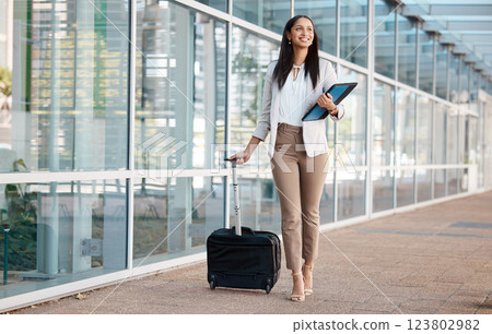 Airport, corporate manager and travel for company business seminar or convention workshop. Happy businesswoman walking with suitcase bag, files in hand and smiling in urban city outdoors Airport, corporate manager and travel for company business seminar or convention workshop. Happy businesswoman walking with suitcase bag, files in hand and smiling in urban city outdoors 123802982