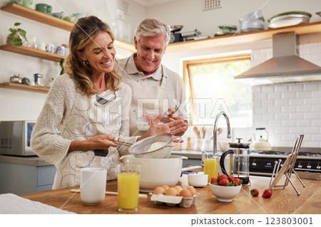 Elderly, couple and in kitchen while cooking, baking and happy together in funny moment. Senior man, woman and retirement smile in home, bonding and smile with love to make cookies, cake and bake Elderly, couple and in kitchen while cooking, baking and happy together in funny moment. Senior man, woman and retirement smile in home, bonding and smile with love to make cookies, cake and bake 123803001