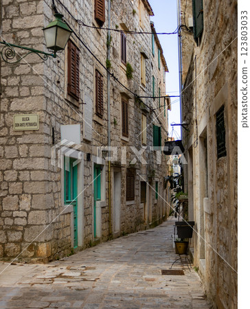 Narrow medieval stone street in ancient villages. European tourism concep Narrow medieval stone street in ancient villages. European tourism concep 123803033