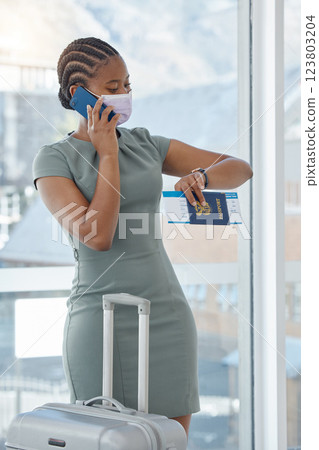 Covid, black woman and cancelled flight phone communication for business travel departure delay. Travel regulation mask girl at South Africa airport on call waiting with luggage and passport. Covid, black woman and cancelled flight phone communication for business travel departure delay. Travel regulation mask girl at South Africa airport on call waiting with luggage and passport. 123803204