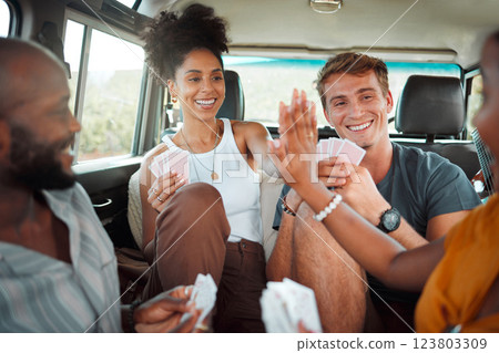 Card game, car and friends high five on a road trip enjoy holidays, vacation or fun weekend together. Winner, happy and excited girls celebrate playing, winning or victory with a smile in a caravan 123803309