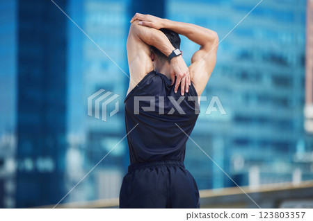Stretching, fitness and athlete training in city for cardio health, body goal and sports motivation in Singapore. Back of a runner doing warm up for performance while running for exercise and workout 123803357