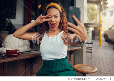 Coffee shop, selfie and black woman with peace hand sign on smartphone for social media post, internet marketing and gen z lifestyle. Cafe, restaurant and influencer customer with cellphone portrait 123803401