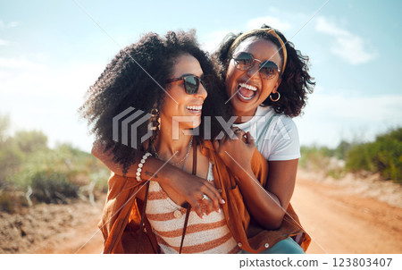 Black women, friends and nature holiday portrait, vacation or summer trip. Safari, sunglasses and girls piggy back, spending time together bonding and having fun in countryside, outdoors or desert. 123803407