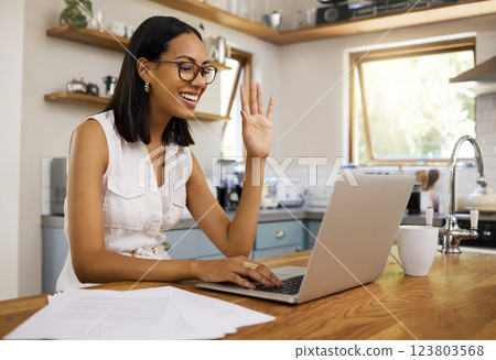 Video call, laptop and woman wave on communication, conversation or talking on digital video conference. Hello, chat or happy Brazil girl relax in home kitchen while speaking on global online contact Video call, laptop and woman wave on communication, conversation or talking on digital video conference. Hello, chat or happy Brazil girl relax in home kitchen while speaking on global online contact 123803568