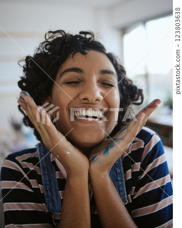 Woman artist, smile, happy and excited in her work studio, her hand with paint. Young painter, art and playful while working in workshop, painting and creative with watercolor during a break. Woman artist, smile, happy and excited in her work studio, her hand with paint. Young painter, art and playful while working in workshop, painting and creative with watercolor during a break. 123803638