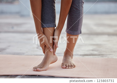 Hands, feet or ankle pain woman on yoga mat in relax workout, training or fitness exercise for health, wellness or mental health. Zoom, woman or foot injury in pilates leg crisis or anatomy emergency Hands, feet or ankle pain woman on yoga mat in relax workout, training or fitness exercise for health, wellness or mental health. Zoom, woman or foot injury in pilates leg crisis or anatomy emergency 123803731
