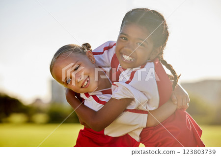 Girl football players, children hug and smile after sports training match for competition. Young football friends, embrace after game and learning collaboration and teamwork together while exercising Girl football players, children hug and smile after sports training match for competition. Young football friends, embrace after game and learning collaboration and teamwork together while exercising 123803739