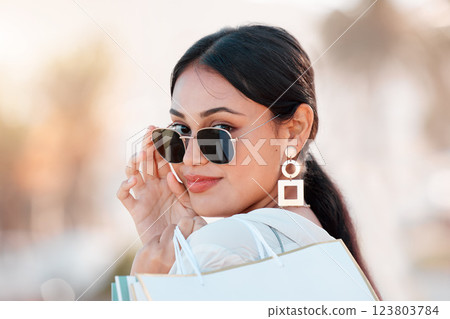 Woman, fashion and shopping happy with sunglasses on face in city after sale, discount and bag from shop. Girl, beauty and portrait with style, confidence and smile in time at mall, store or boutique Woman, fashion and shopping happy with sunglasses on face in city after sale, discount and bag from shop. Girl, beauty and portrait with style, confidence and smile in time at mall, store or boutique 123803784