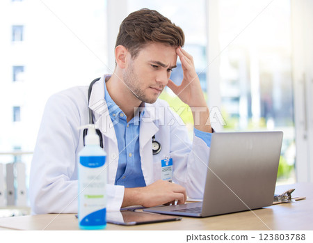 Headache pain, doctor stress and laptop with burnout from hospital work, sad about mental health problem and anxiety working in healthcare. Tired medical expert with depression and mistake at clinic 123803788