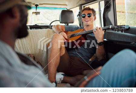 Man with guitar, music in van and smile on travel vacation road trip together with friends. Group holiday in summer, relax and happy musician singing with instrument on a countryside safari adventure Man with guitar, music in van and smile on travel vacation road trip together with friends. Group holiday in summer, relax and happy musician singing with instrument on a countryside safari adventure 123803789