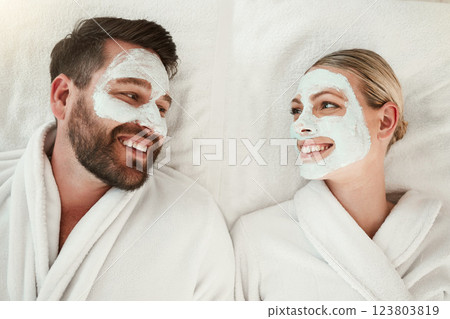 Love, face mask and skincare couple relax, body care and in gowns on spa vacation celebrate anniversary, honeymoon or relationship. Man and woman on holiday smile together, on retreat and bonding. 123803819