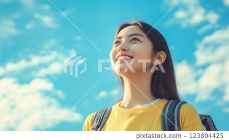 Female College Student Portrait With Clear Blue Sky Background Suitable For Copy Space And Graphic Design Elements. Perfect For Marketing Materials. 123804425