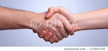 A close-up of two hands shaking, representing partnership and agreement. 123805395